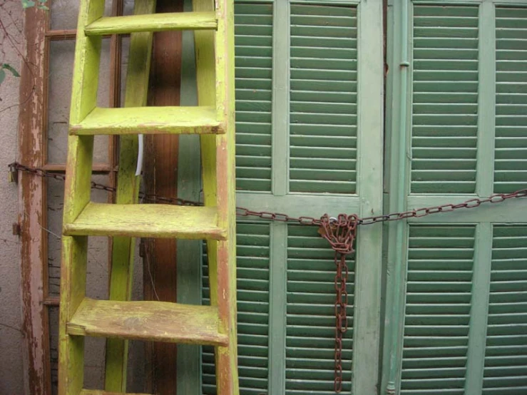 two green wooden ladders near one another