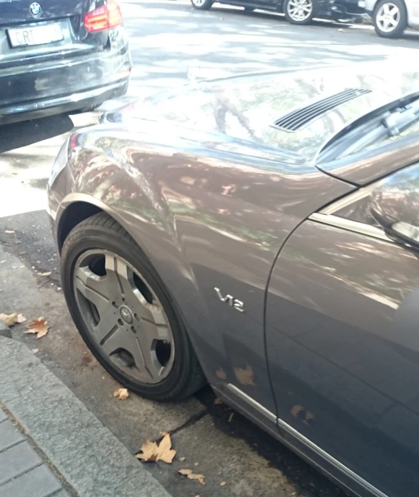 the rear end of a car parked on the side of a road