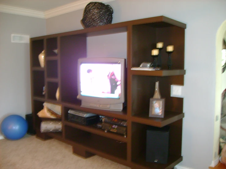 a television set sitting on top of a wooden cabinet