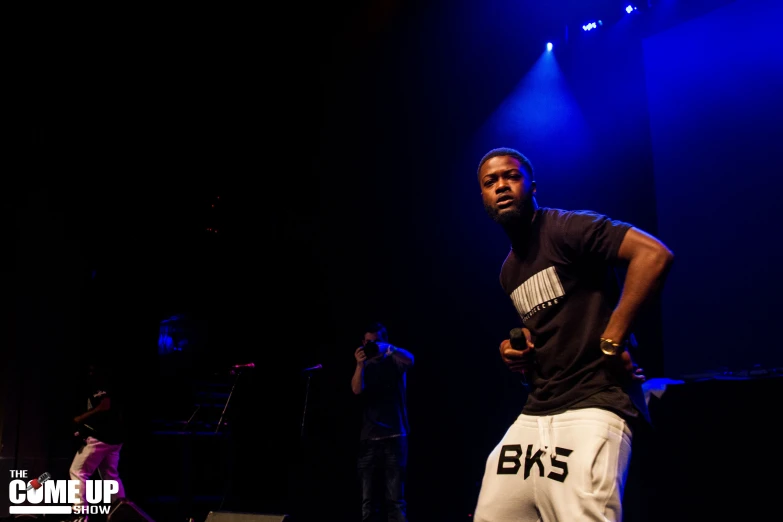 the man is walking on stage during the performance