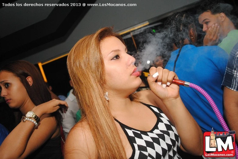 a young woman smoking a cigarette at a club