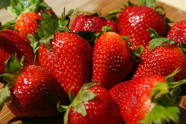 a closeup of a pile of fresh strawberries