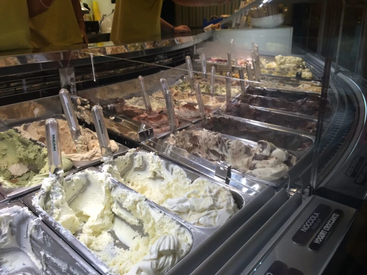 several scoops of ice cream sit in the display cases