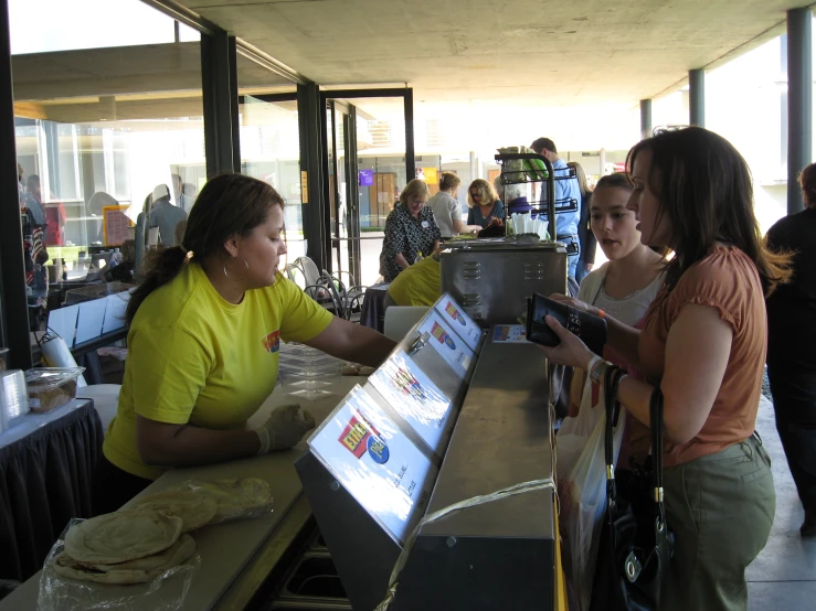 three women at a food court check out their menu