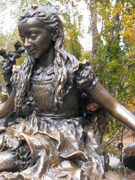 a close up of a statue with trees in the background