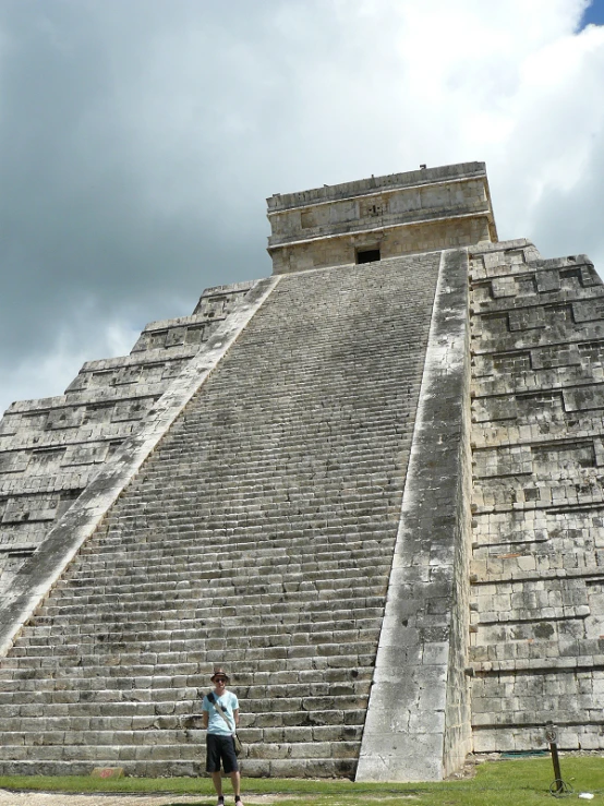 there is a man standing at the base of the pyramid