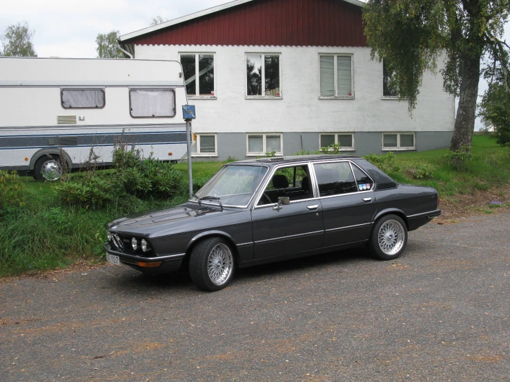 a black sedan parked in front of a home