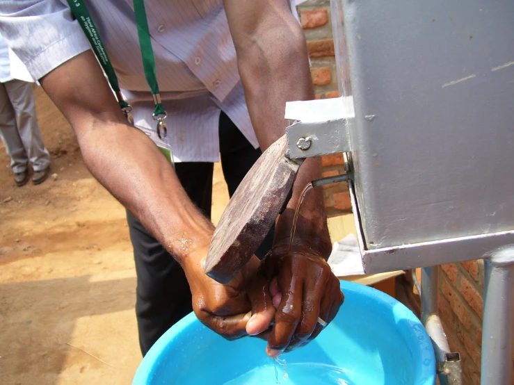 someone is using a water source to wash a banana