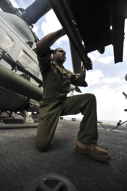 a man is standing next to an airplane with the wheels down