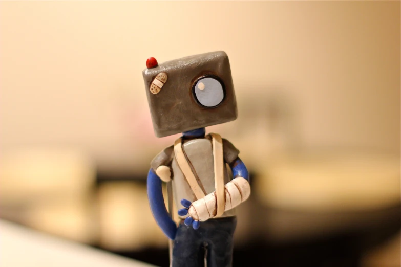 the tiny robot with big eyes is standing alone