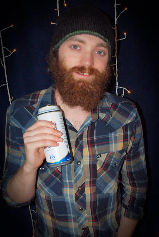 a man with a long beard holding up a beer
