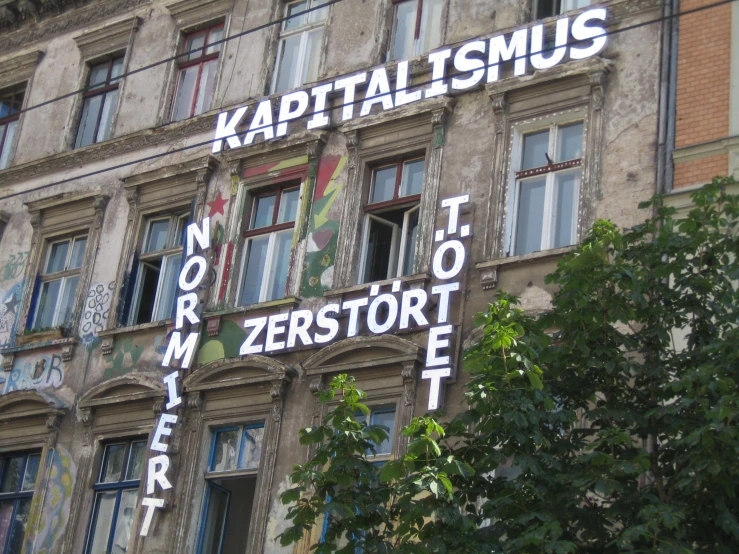 a building with lots of windows and white lettering on it