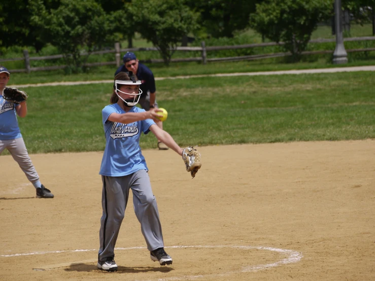 the little league baseball player throws the ball