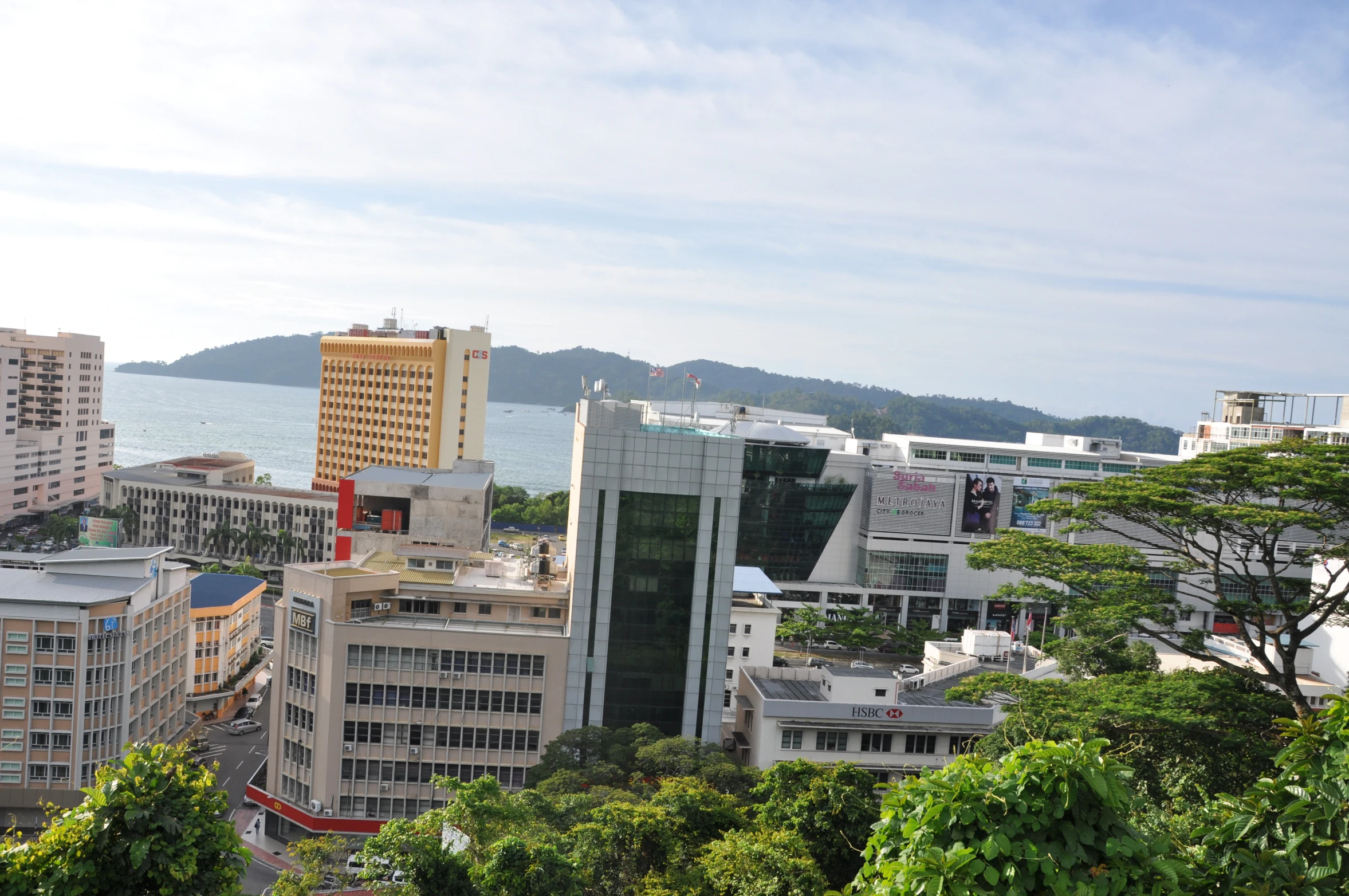 the city skyline with mountains and water behind it