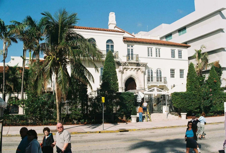 people are standing in the road in front of an old building