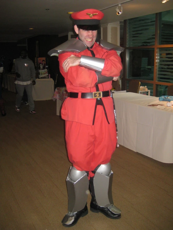 a man in a red costume is smiling for the camera