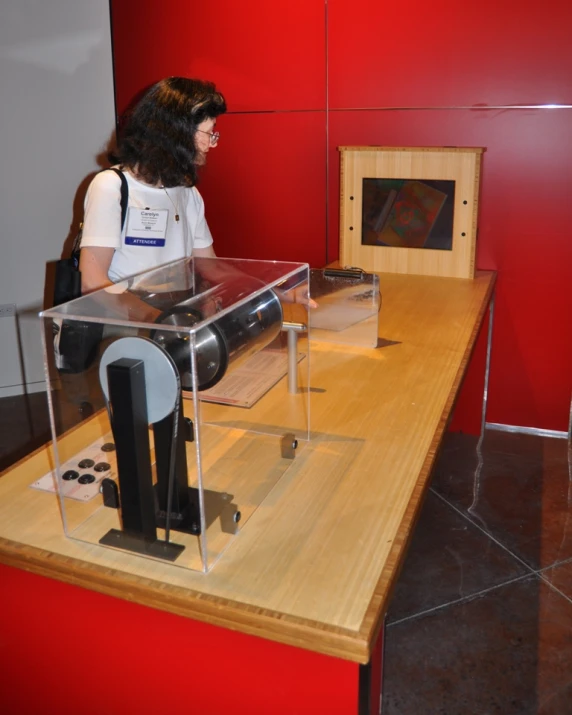 a woman looking through a microscope in a case