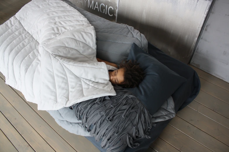 a man lays down with his back against pillows