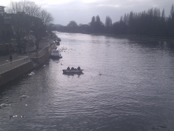 several people in a rowboat are traveling down the river