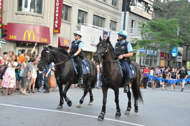 policemen riding horses on a city street