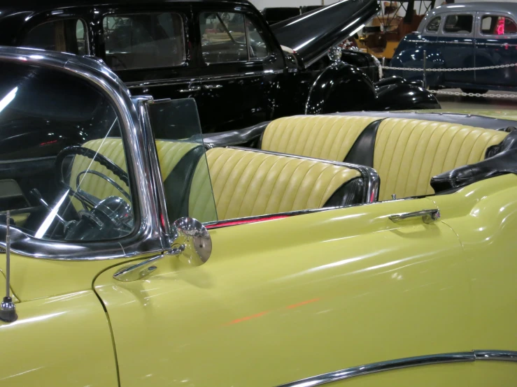 the interior of an old car with classic cars around it