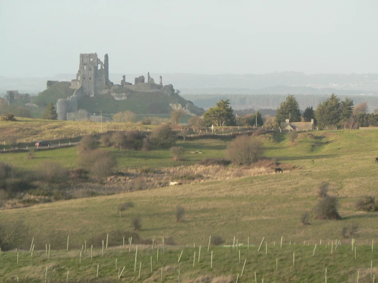 an overview view of a castle and a grassy hillside