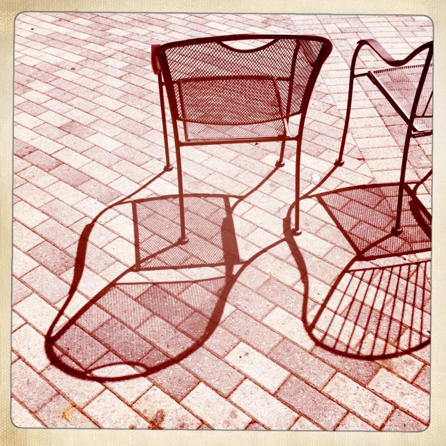 two chairs and a table with one chair and the other chair