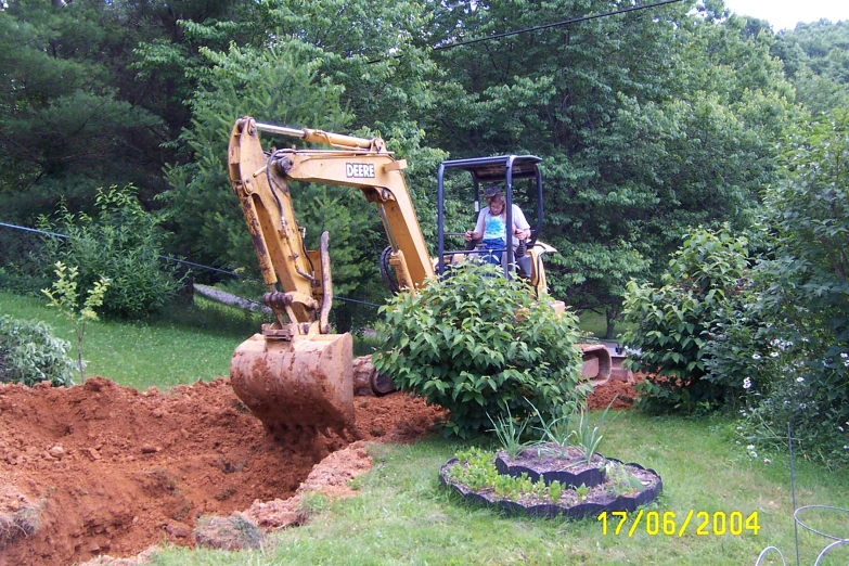 there is a digger shovel digging into the dirt