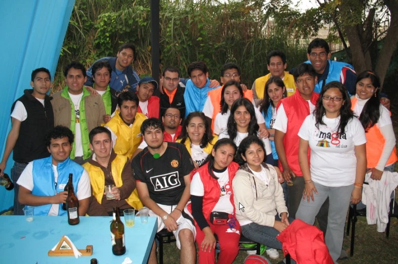 a large group of people in various sports uniforms are posing for a group po