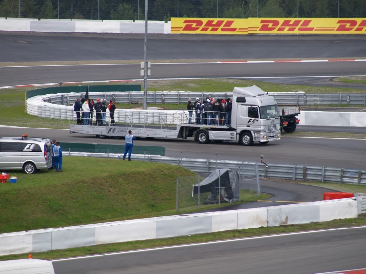 a truck and truck carrying several passengers on a track