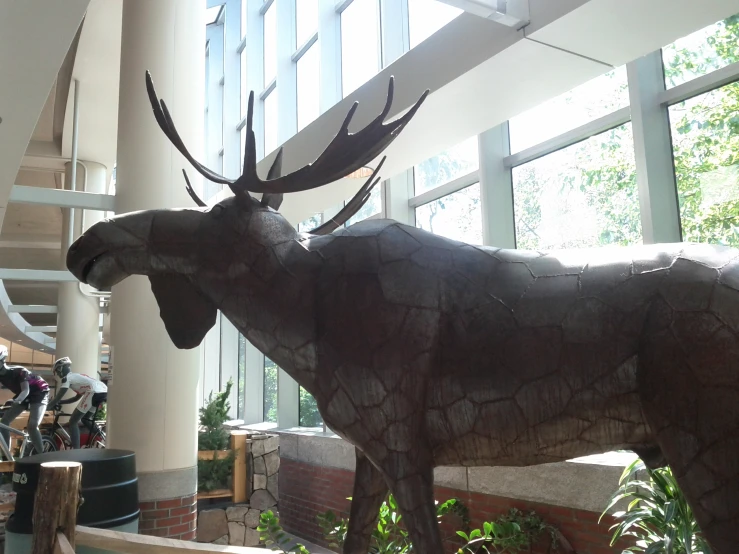 a metal statue of a moose in a building