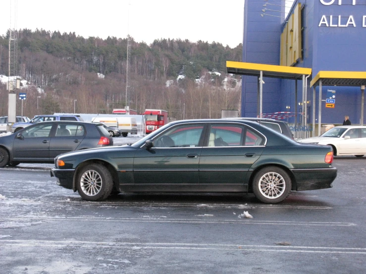 cars are parked in a snowy parking lot