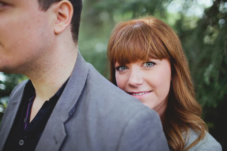 the man and woman are posing for pictures