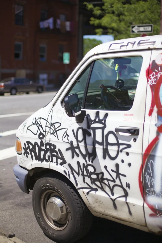 a white car is covered in black and red graffiti