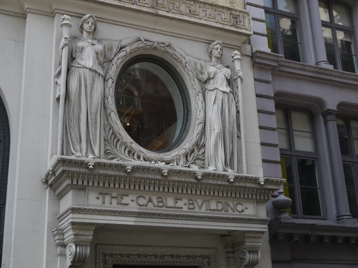 the building has three statues over it
