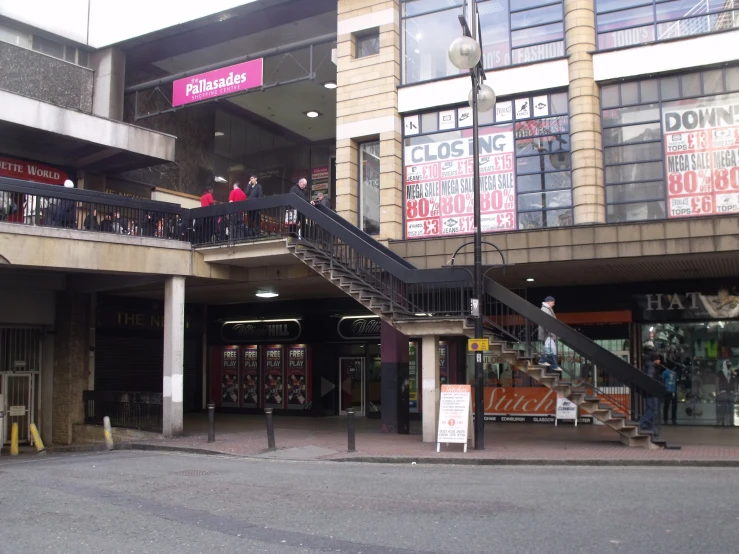 people are walking into a building with metal handrails