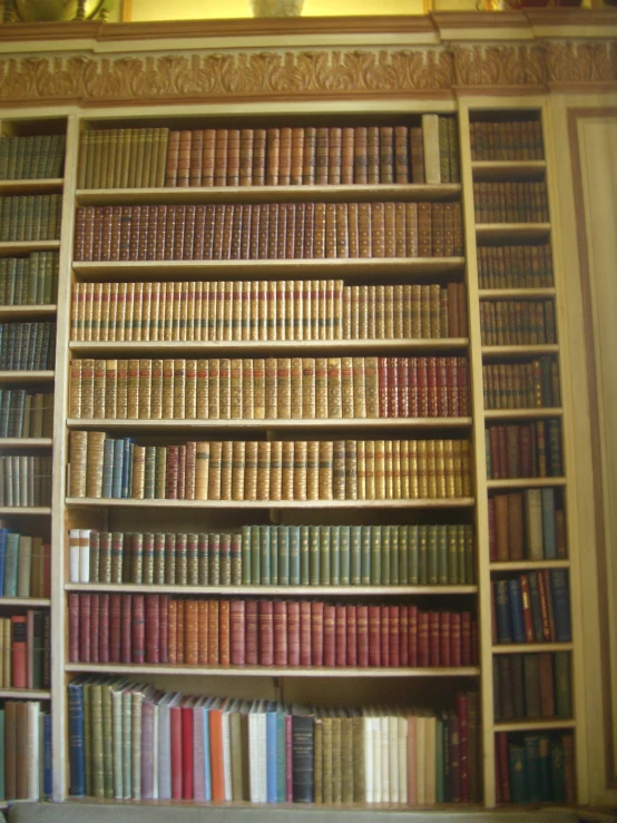 a large bookshelf with lots of different colored books on it