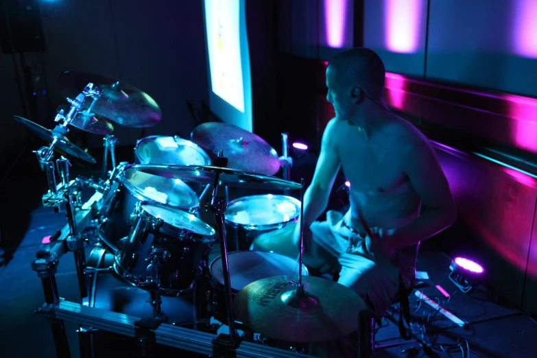 a drummer is posing with his drum set on stage