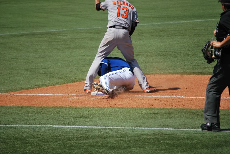 a baseball player sliding into base in front of the crowd