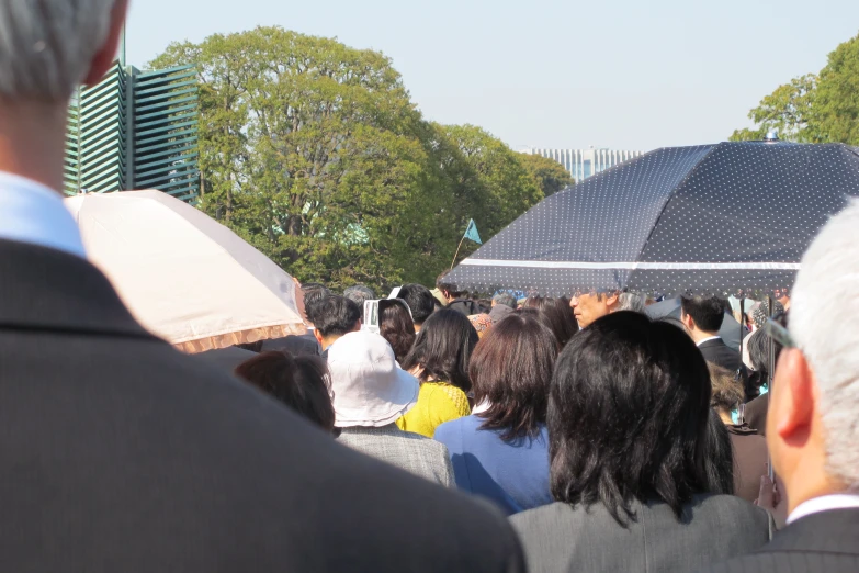 people walking down a road holding open umbrellas