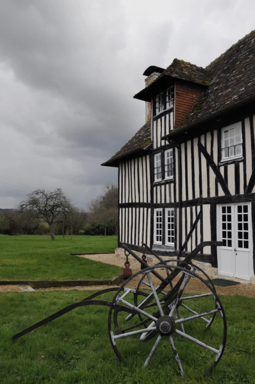 a large house with an ornate wooden and iron wheel