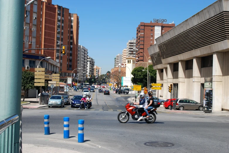 people are riding motorcycles and cars on the street