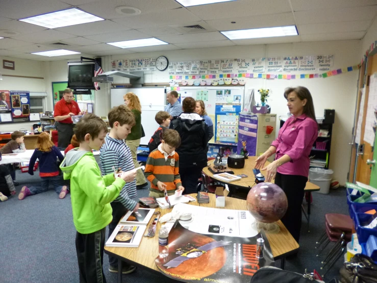 a group of people are standing around in the room