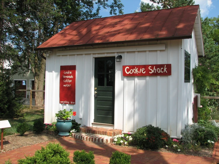 a white shack with some red writing on the door