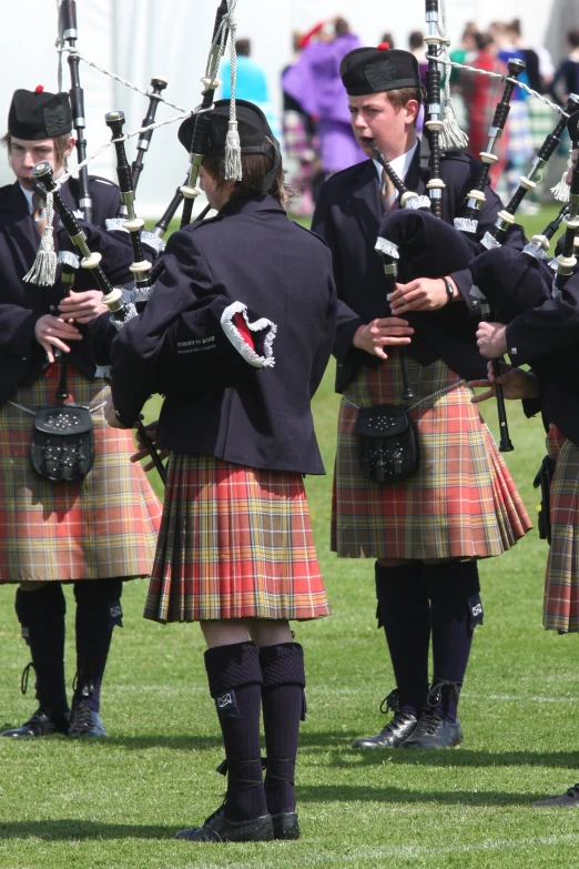 men in kilts performing scottish dances for spectators