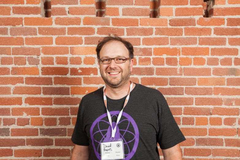 a man is wearing a black shirt and posing for a po