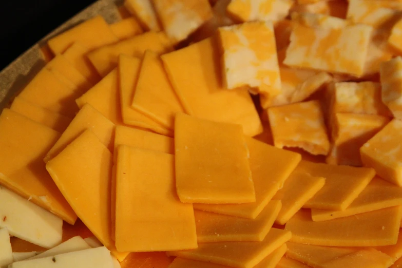some pieces of cheese are placed together on a plate