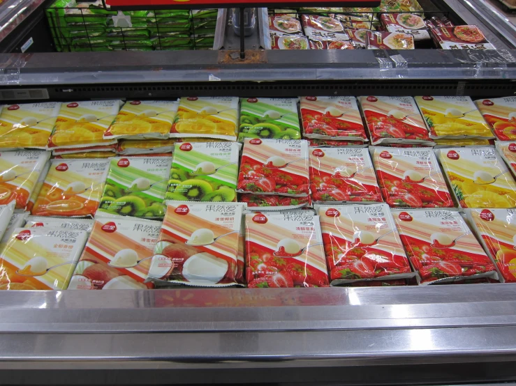 some fruit packets are on a conveyor belt in a grocery store