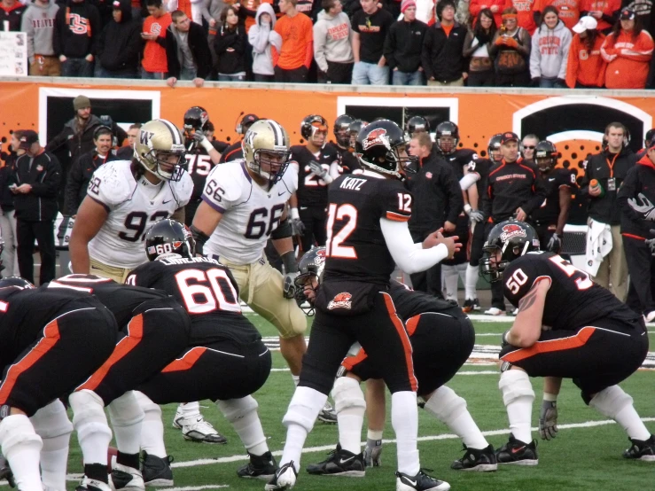 several football players, including one player wearing uniform and the other wearing white