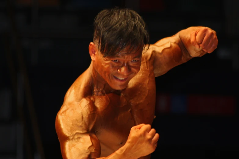 an old man shows off his muscles in the bodybuilding competition